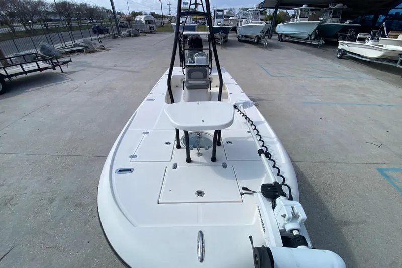 Slide: The Image of 2022 Composite Research Spyder FX-19 Vapor boat in a marina, showcasing deck and seating. - 15