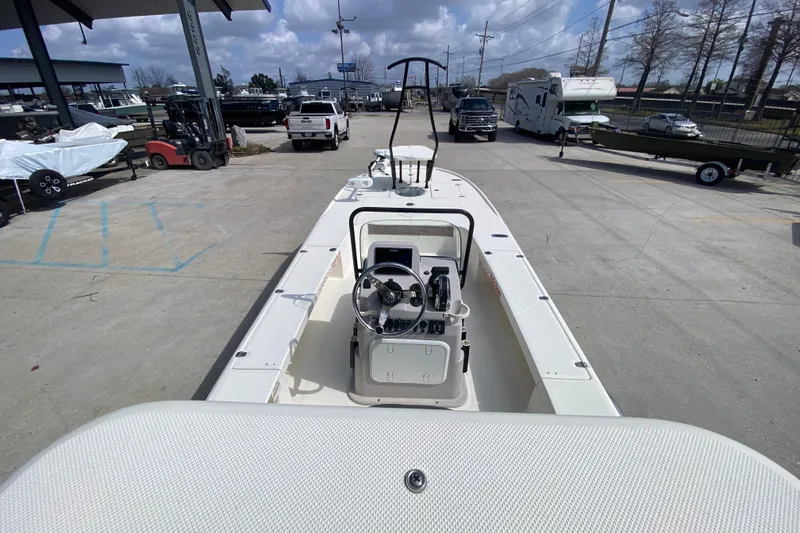 Slide: The Image of 2022 Composite Research Spyder FX-19 Vapor boat at a dealership, showcasing steering console. - 26