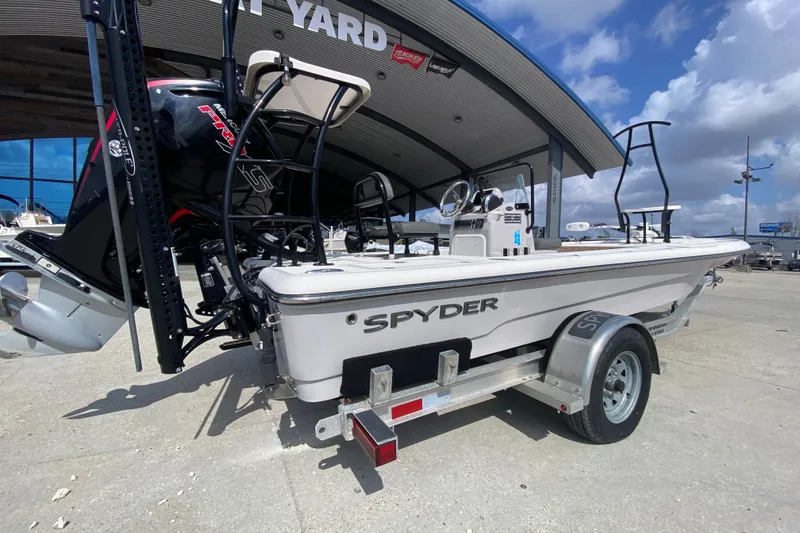 Slide: The Image of 2022 Composite Research Spyder FX-19 Vapor boat on trailer, outdoor dealership setting. - 5