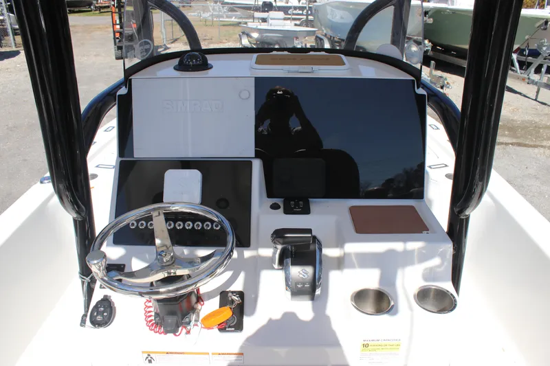 Slide: The Image of 2022 Sea Pro 248 Bay boat dashboard with steering wheel and controls. - 11