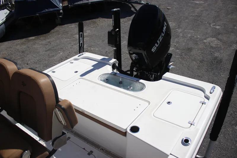 Slide: The Image of 2022 Sea Pro 248 Bay boat with Suzuki outboard motor, featuring tan seating and storage compartments. - 7