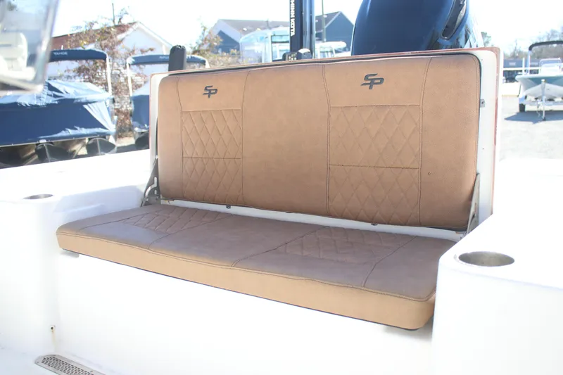 Slide: The Image of 2022 Sea Pro 248 Bay boat with tan cushioned seating and diamond stitching. - 9