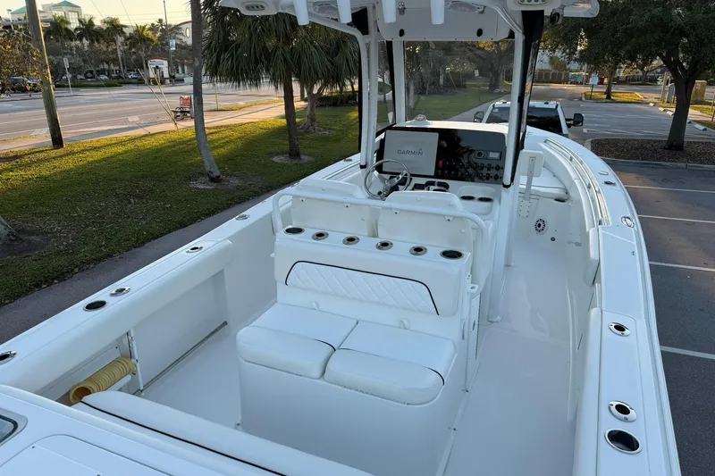 Slide: The Image of 2014 Sea Hunt Gamefish 27 boat interior with seating and Garmin navigation system. - 10
