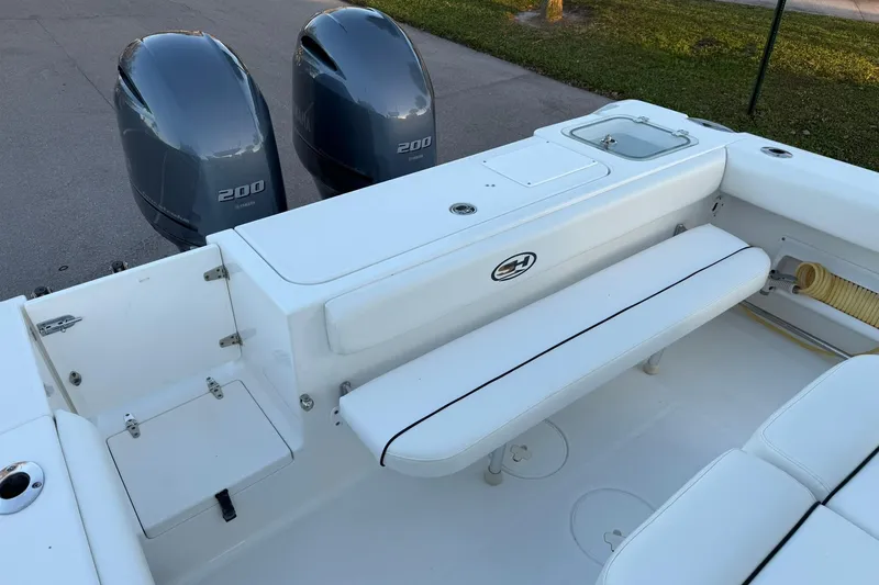 Slide: The Image of 2014 Sea Hunt Gamefish 27 boat with twin Yamaha 200 engines, white seating area. - 11