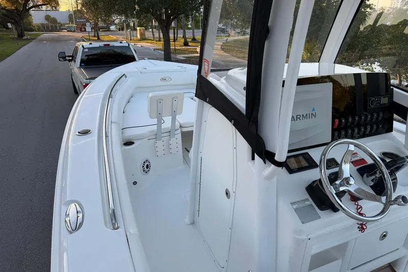 Slide: The Image of 2014 Sea Hunt Gamefish 27 boat with Garmin navigation, parked on a street. - 20