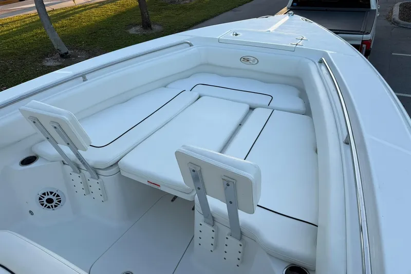 Slide: The Image of 2014 Sea Hunt Gamefish 27 boat with white cushioned seating and sleek design. - 22