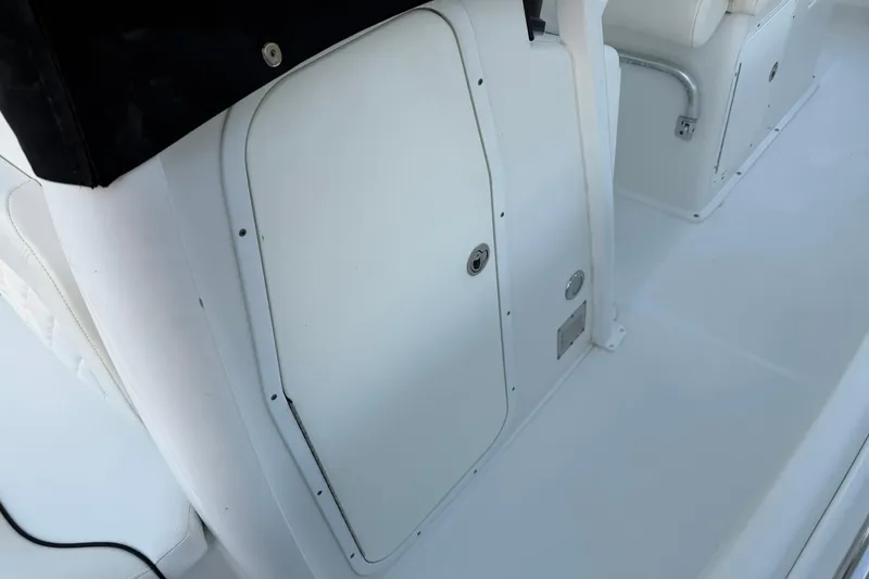 Slide: The Image of 2014 Sea Hunt Gamefish 27 boat interior, featuring a white storage compartment. - 26