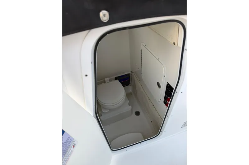 Slide: The Image of 2014 Sea Hunt Gamefish 27 boat interior with compact marine toilet. - 27