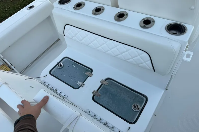Slide: The Image of 2014 Sea Hunt Gamefish 27 boat interior with rod holders and storage compartments. - 29