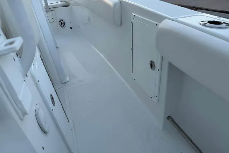 Slide: The Image of 2014 Sea Hunt Gamefish 27 interior deck, featuring storage compartments and rod holders. - 31