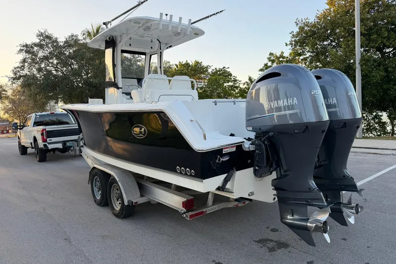 Slide: The Image of 2014 Sea Hunt Gamefish 27 boat on trailer with dual Yamaha engines. - 5