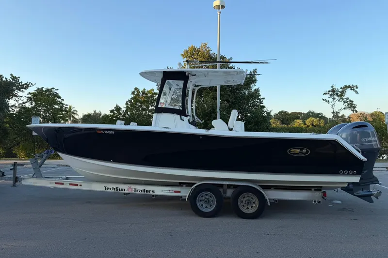 Slide: The Image of 2014 Sea Hunt Gamefish 27 boat on trailer, parked outdoors. - 6