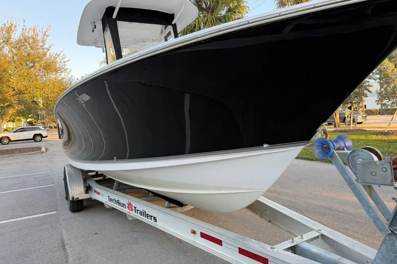 Slide: The Image of 2014 Sea Hunt Gamefish 27 boat on trailer in parking lot. - 9