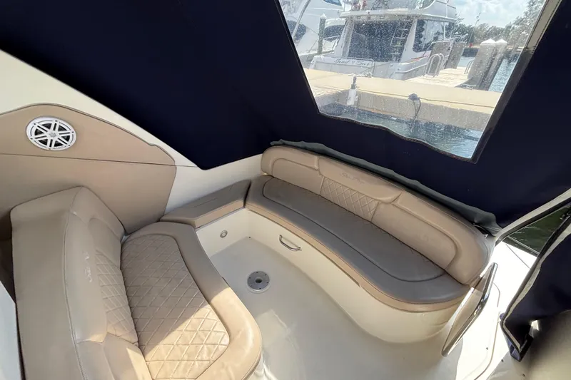 Slide: The Image of 2009 Sea Ray Sundancer 310 interior with beige leather seating and window view. - 12