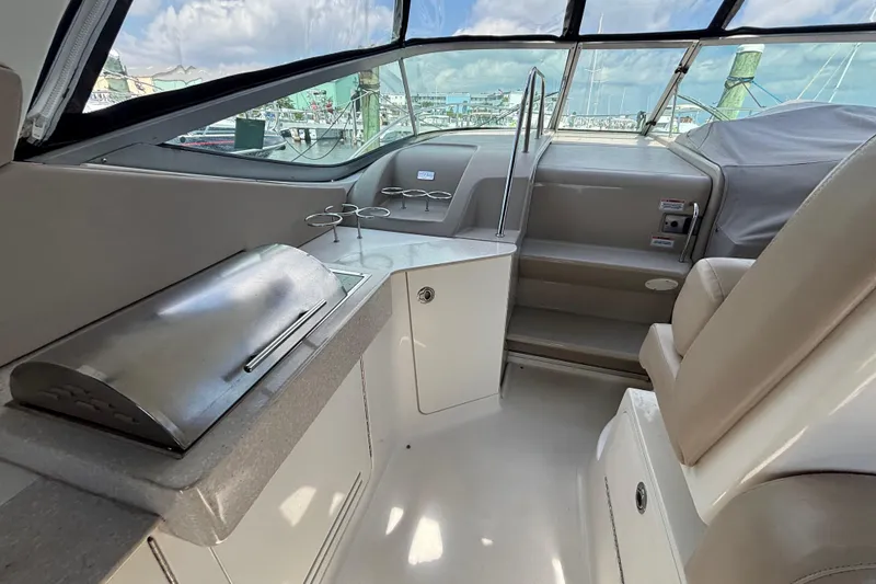 Slide: The Image of 2009 Sea Ray Sundancer 310 interior with grill and seating, showcasing luxury yacht features. - 15