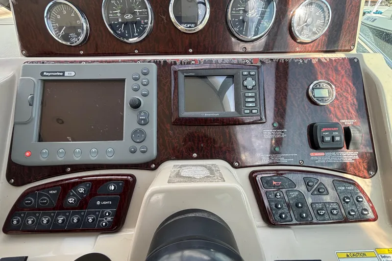 Slide: The Image of Dashboard of 2009 Sea Ray Sundancer 310 with navigation and control panels. - 20