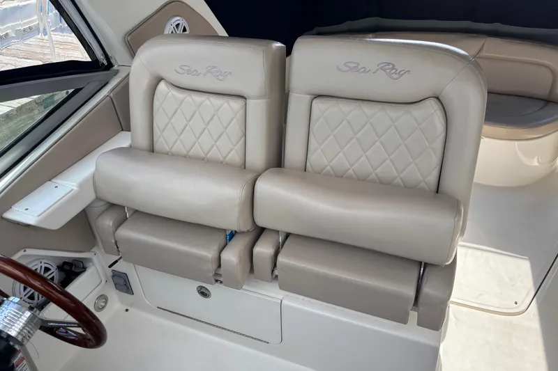 Slide: The Image of 2009 Sea Ray Sundancer 310 cockpit with beige leather seats and steering wheel. - 21