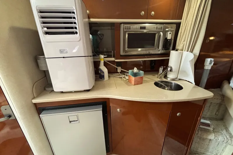 Slide: The Image of 2009 Sea Ray Sundancer 310 galley with microwave, sink, and mini fridge. - 27