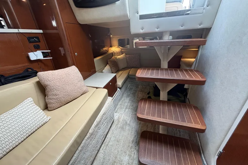 Slide: The Image of 2009 Sea Ray Sundancer 310 interior with cozy seating and wooden steps. - 29