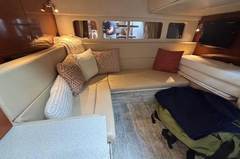 Slide: The Image of Interior of 2009 Sea Ray Sundancer 310 with beige seating and decorative pillows. - 30