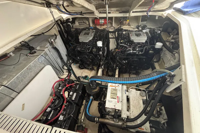 Slide: The Image of Engine compartment of a 2009 Sea Ray Sundancer 310, featuring dual engines and battery setup. - 33