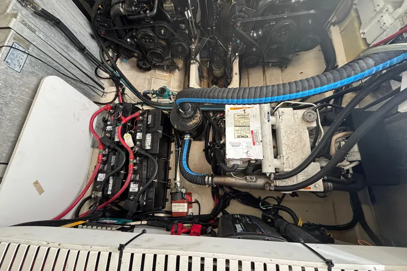 Slide: The Image of Engine compartment of a 2009 Sea Ray Sundancer 310, showcasing batteries and mechanical components. - 36