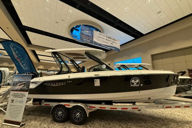 Slide: The Image of 2026 Monterey Elite 27 OB boat displayed indoors on a trailer. - 0
