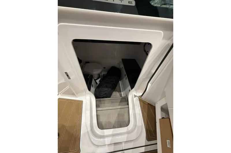 Slide: The Image of Interior cabin view of 2026 Monterey Elite 27 OB boat, featuring compact amenities. - 11