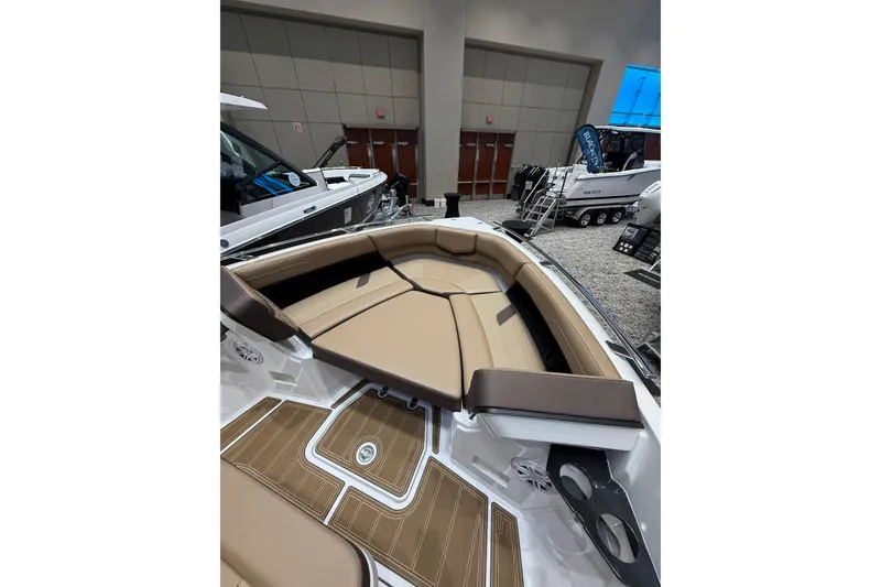 Slide: The Image of 2026 Monterey Elite 27 OB boat interior with tan seating and wood accents. - 12