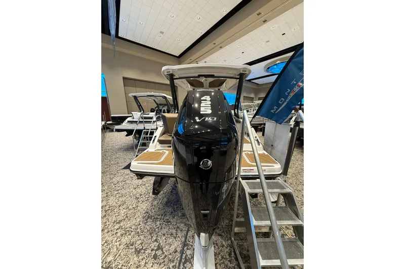 Slide: The Image of 2026 Monterey Elite 27 OB boat with powerful outboard engine displayed indoors. - 3