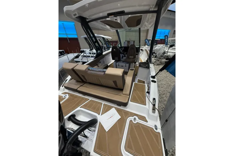 Slide: The Image of 2026 Monterey Elite 27 OB boat interior with tan seating and modern design. - 4
