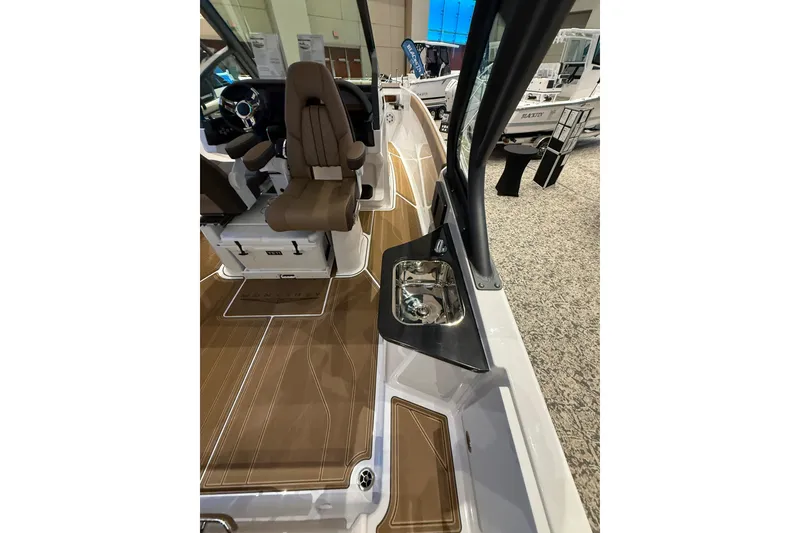 Slide: The Image of 2026 Monterey Elite 27 OB boat interior with brown seating and sleek design. - 5