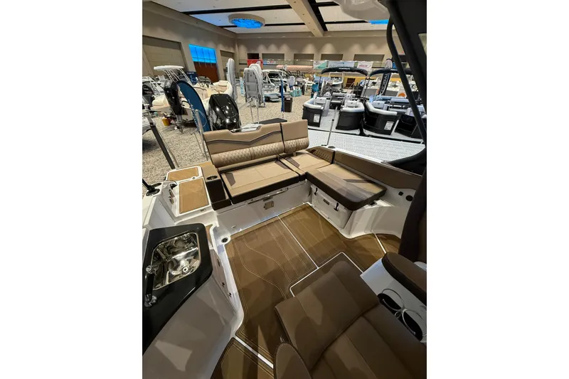Slide: The Image of 2026 Monterey Elite 27 OB boat interior with luxurious seating at a showroom display. - 9
