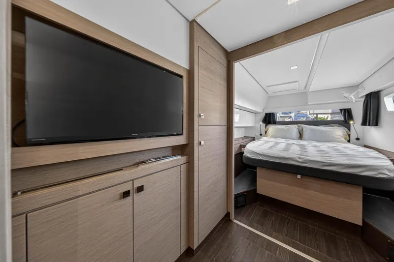 Slide: The Image of Luxurious 2022 Fountaine Pajot Tanna 47 yacht bedroom with TV and modern decor. - 101