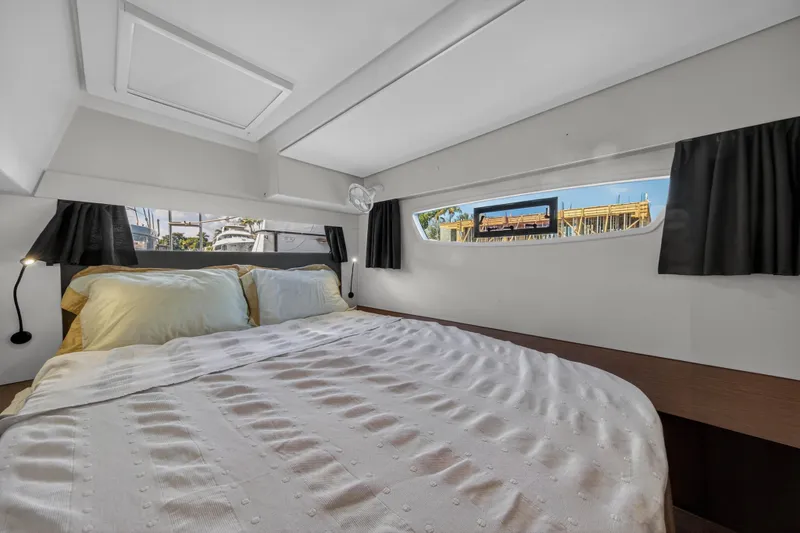 Slide: The Image of Interior cabin of 2022 Fountaine Pajot Tanna 47 catamaran, featuring a cozy bed and windows. - 103