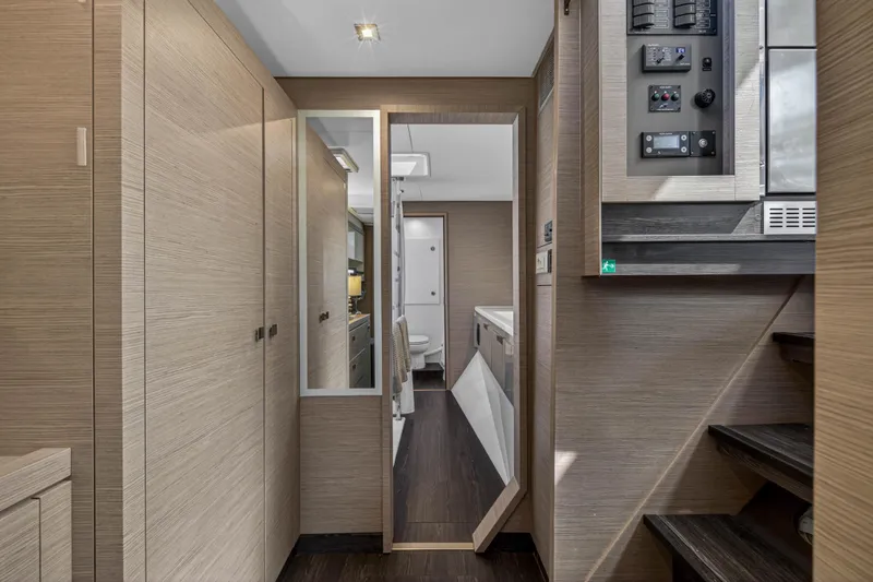 Slide: The Image of Interior of 2022 Fountaine Pajot Tanna 47 yacht, featuring modern wood paneling and control panel. - 106