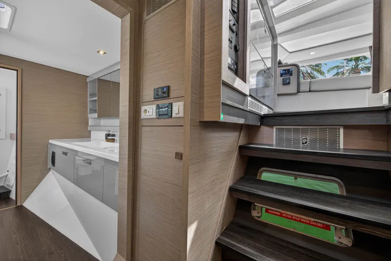 Slide: The Image of Interior of 2022 Fountaine Pajot Tanna 47 yacht, featuring modern kitchen and staircase. - 107