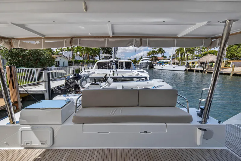 Slide: The Image of 2022 Fountaine Pajot Tanna 47 yacht docked, featuring a spacious outdoor seating area. - 19