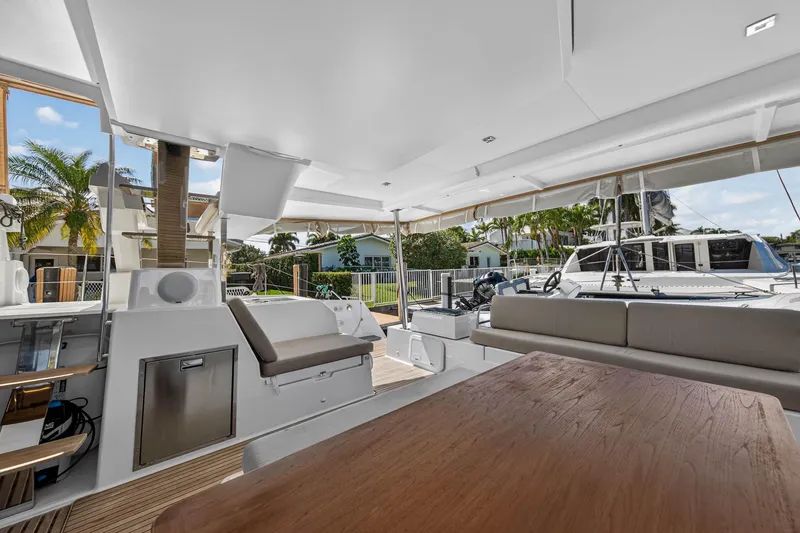 Slide: The Image of 2022 Fountaine Pajot Tanna 47 yacht deck with seating and outdoor dining area. - 25