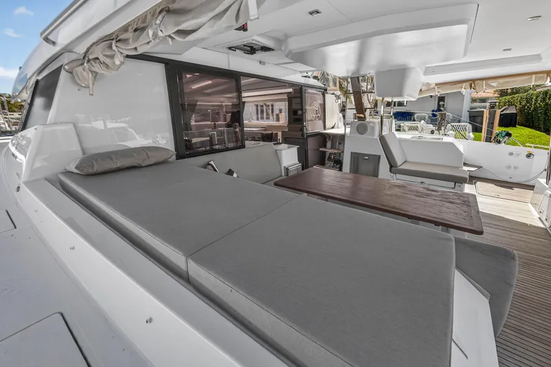 Slide: The Image of 2022 Fountaine Pajot Tanna 47 yacht with spacious outdoor seating and dining area. - 30