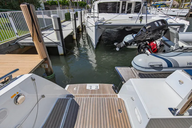 Slide: The Image of 2022 Fountaine Pajot Tanna 47 catamaran docked with inflatable boat nearby. - 31