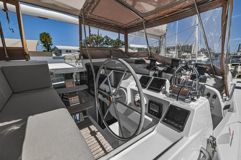 Slide: The Image of 2022 Fountaine Pajot Tanna 47 yacht cockpit with modern steering and navigation equipment. - 33