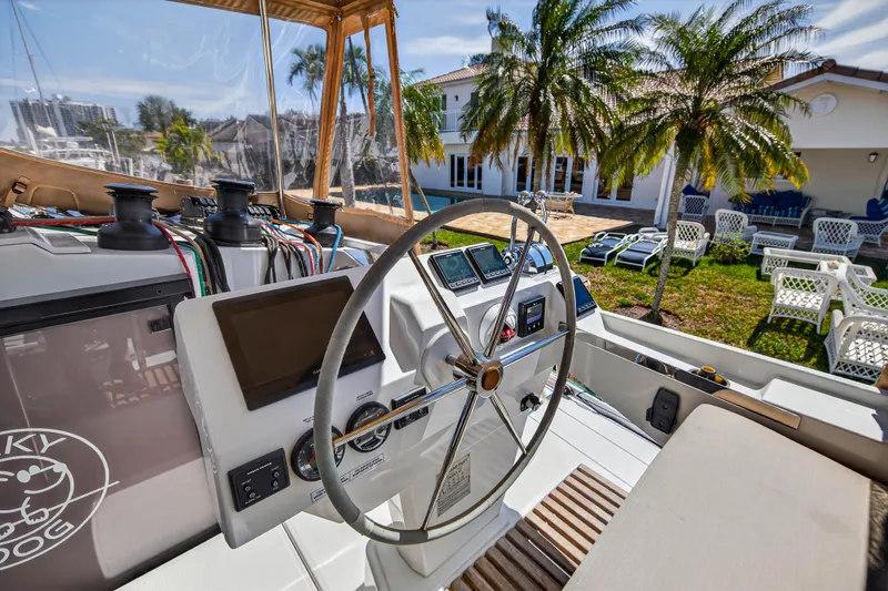 Slide: The Image of Helm of 2022 Fountaine Pajot Tanna 47 catamaran with modern controls and tropical backdrop. - 34