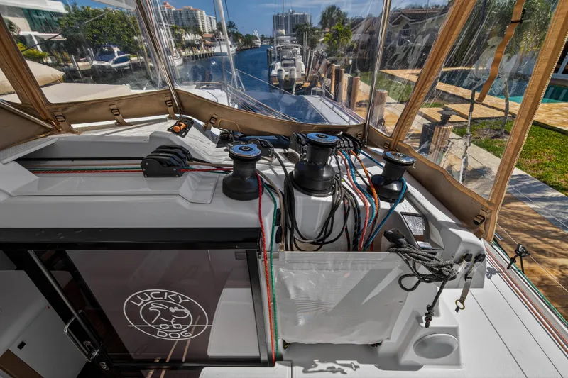 Slide: The Image of 2022 Fountaine Pajot Tanna 47 yacht deck with winches and ropes, docked in a marina. - 37