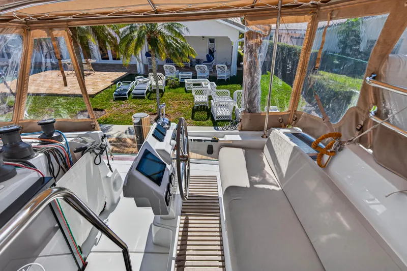 Slide: The Image of 2022 Fountaine Pajot Tanna 47 yacht cockpit with helm, overlooking garden and patio. - 41