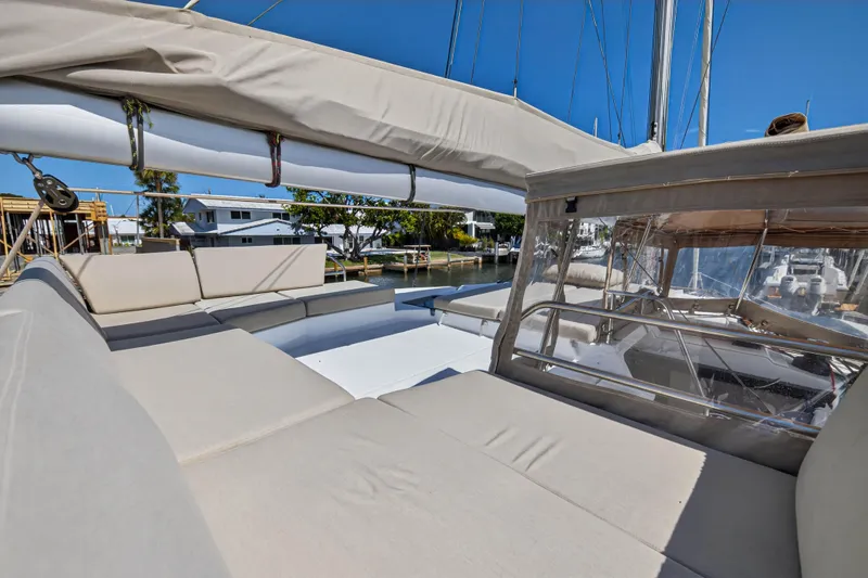 Slide: The Image of 2022 Fountaine Pajot Tanna 47 yacht with spacious outdoor seating and clear skies. - 46