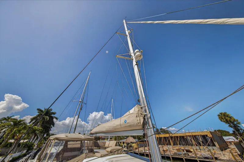 Slide: The Image of 2022 Fountaine Pajot Tanna 47 sailboat mast against clear blue sky. - 57