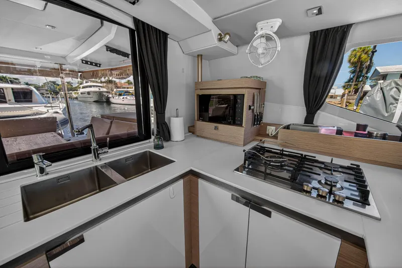 Slide: The Image of Modern kitchen interior of 2022 Fountaine Pajot Tanna 47 yacht with waterfront view. - 67
