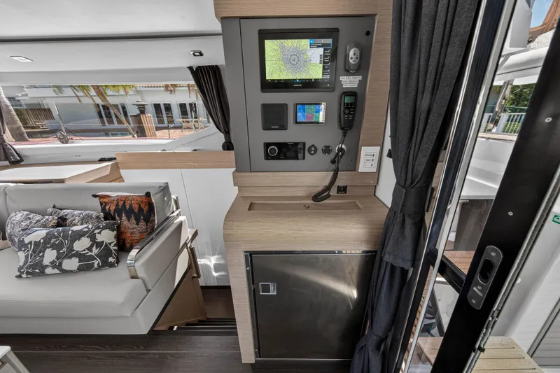 Slide: The Image of 2022 Fountaine Pajot Tanna 47 yacht interior with navigation panel and cozy seating area. - 75