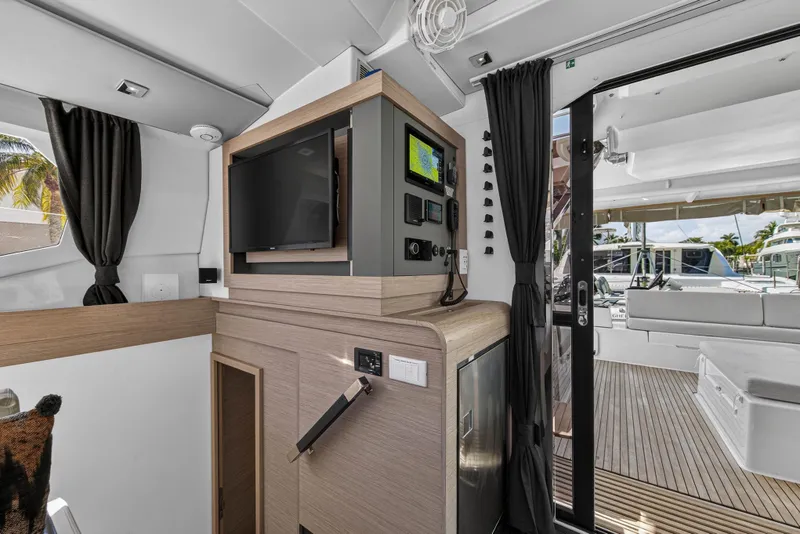Slide: The Image of Interior of 2022 Fountaine Pajot Tanna 47 yacht with modern navigation equipment and outdoor seating. - 76